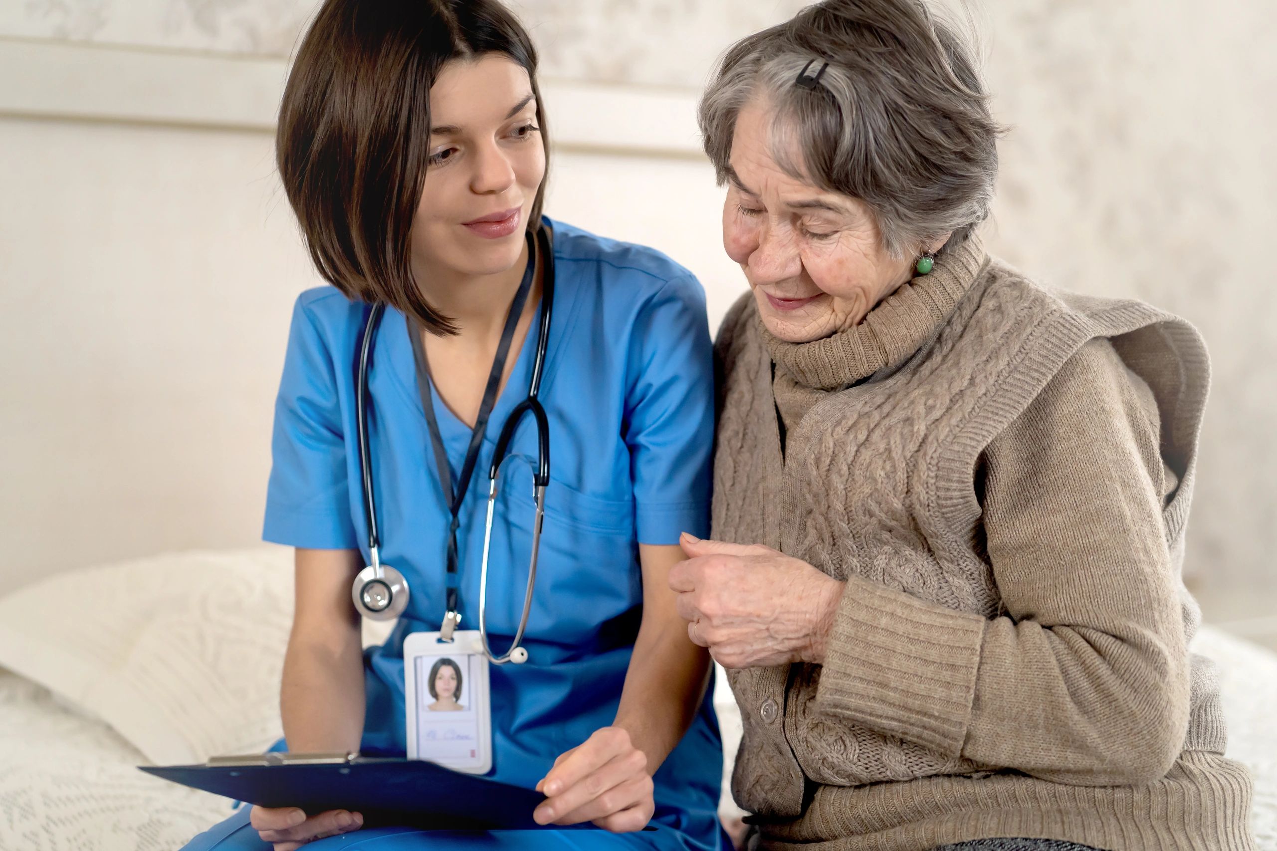 Young nurse caring for elderly person