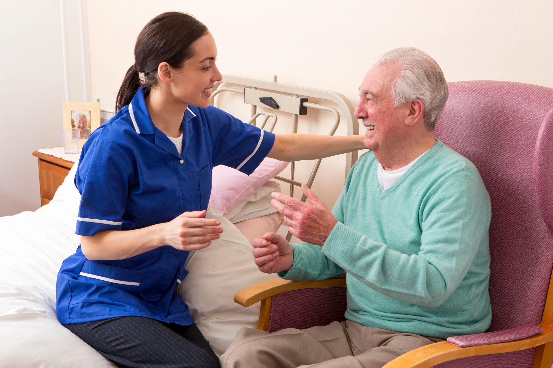 Nurse in hospital ward with senior